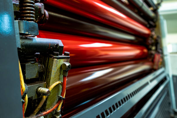 istock Color and glossy rollers of offset printing machine. Magenta 1386229914