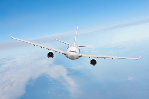 istock Airplane flies above the clouds high in the sky. 1386230439