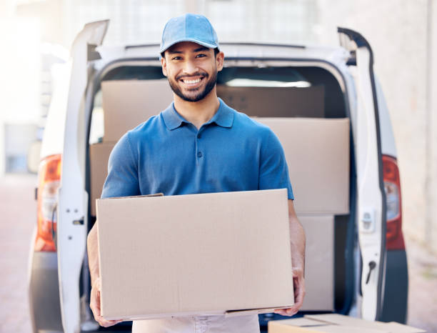 istock Shot of a delivery man standing by his van 1386232924