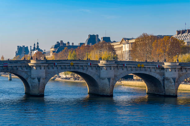 istock Historic Bridge Over the Seine River in Paris With Fall Colors Monuments and Architecture 1386234755