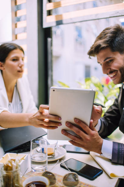 istock Hard work ensures success. Concentrated young woman using pc tablet with his partner 1386235527