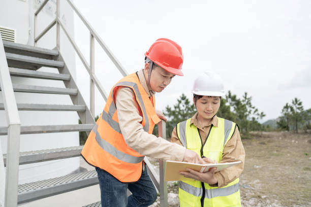istock Two young Asian engineers are working on wind energy. 1386237270