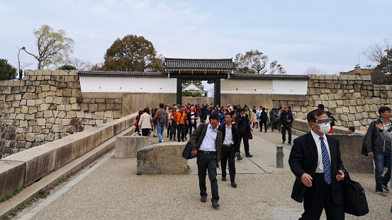 Osaka, Japan - March 28, 2019:  Entrance Gate to Osaka Castle Park. Osaka, Japan. Visitors enter the impressive gate