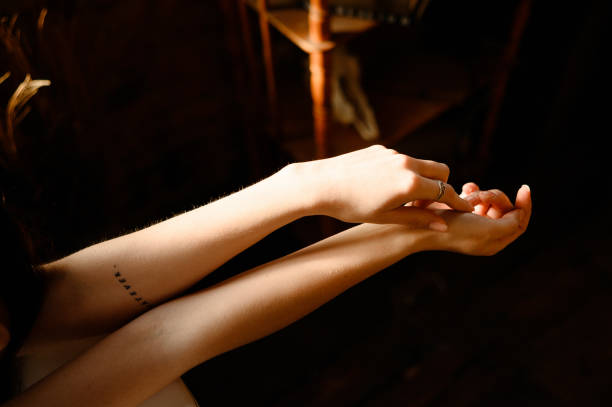 istock Hands of a young woman in a warm light 1386239655