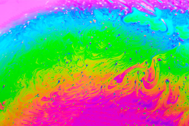 istock Abstract background with colorful rainbow gradient colors. Soap bubble close up psychedelic macro abstraction. Art design 1386246064
