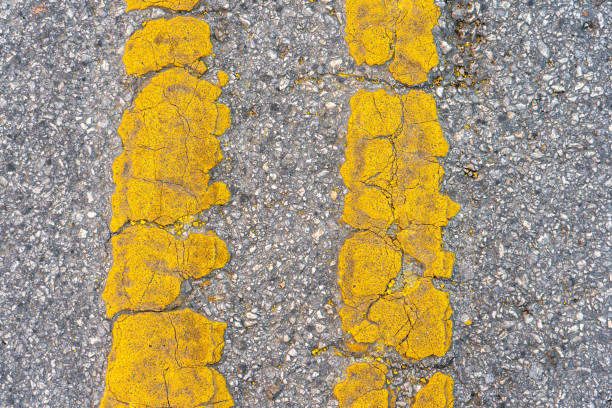 istock Top View of Old YEllow Double Lines During the Day Time 1386246193