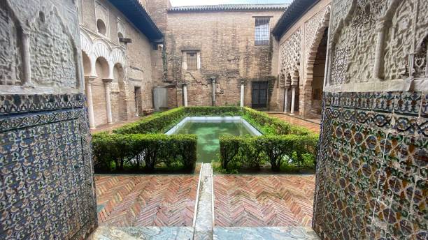 Gardens of Reales Alcázares de Sevilla, a palace decorated in Arabic style Sevilla, Spain – March 13, 2022: Gardens of Reales Alcázares de Sevilla, a palace decorated in Arabic style. alcazares reales of sevilla stock pictures, royalty-free photos & images