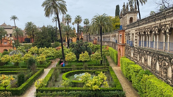 Sevilla, Spain – March 13, 2022: Gardens of Reales Alcázares de Sevilla, a palace decorated in Arabic style.