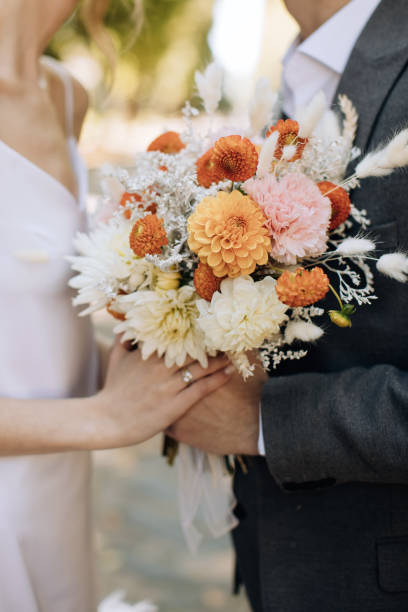 istock The bride and groom hold a beautiful wedding bouquet in a rustic style. Wedding accessories 1386249507