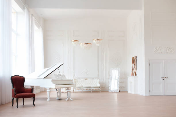 rich luxury interior of a classic style room with vintage furniture, big windows, mirror, chandeliers and grand piano. - piano interior imagens e fotografias de stock