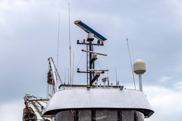 Radar and antennas on the top of the boat with a clear sky.