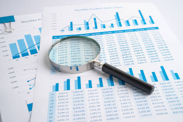 istock Magnifying glass on charts graphs paper. Financial development, Banking Account, Statistics, Investment Analytic research data economy, Stock exchange trading, Business office company meeting concept. 1386256646