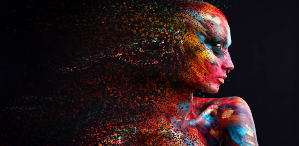 shot of a disintegration effect on a young woman posing in the studio with paint on her face and body - beautiful confidence bizarre exoticism imagens e fotografias de stock