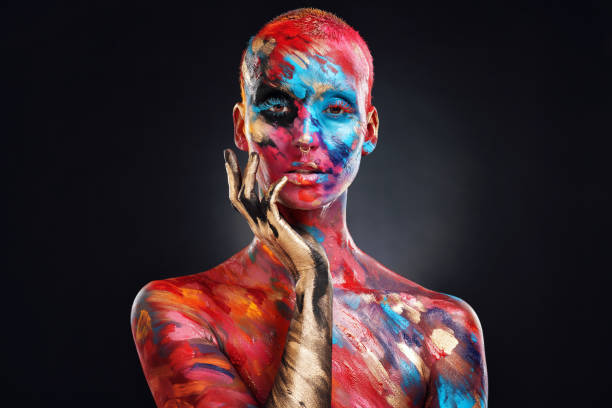 shot of an attractive young woman posing alone in the studio with paint on her face and body - beautiful confidence bizarre exoticism imagens e fotografias de stock