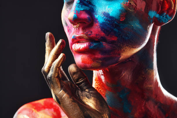 cropped shot of an unrecognisable woman posing alone in the studio with paint on her face - beautiful confidence bizarre exoticism imagens e fotografias de stock