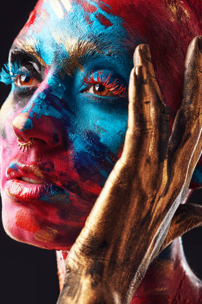 shot of an attractive young woman posing alone in the studio with paint on her face - beautiful confidence bizarre exoticism imagens e fotografias de stock