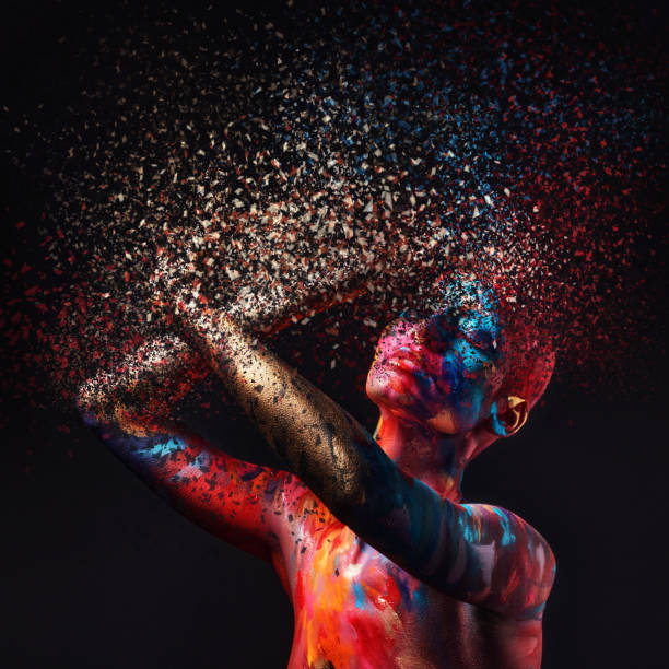 shot of a disintegration effect on a young woman posing in the studio with paint on her face and body - beautiful confidence bizarre exoticism imagens e fotografias de stock