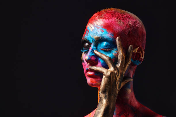 shot of an attractive young woman posing alone in the studio with paint on her face - beautiful confidence bizarre exoticism imagens e fotografias de stock