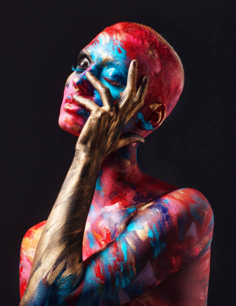 shot of an attractive young woman posing alone in the studio with paint on her face and body - beautiful confidence bizarre exoticism imagens e fotografias de stock