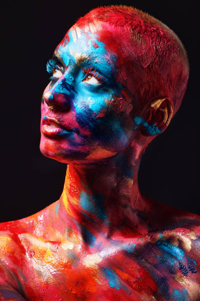 shot of an attractive young woman posing alone in the studio with paint on her face and body - beautiful confidence bizarre exoticism imagens e fotografias de stock