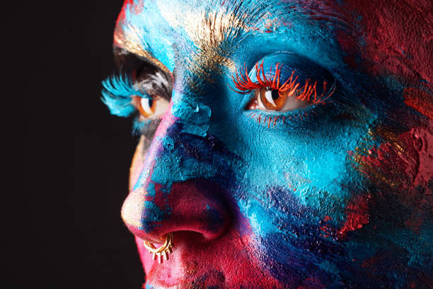 cropped shot of an unrecognisable woman posing alone in the studio with paint on her face - beautiful confidence bizarre exoticism imagens e fotografias de stock