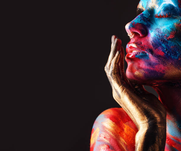 cropped shot of an attractive young woman posing alone in the studio with paint on her face - beautiful confidence bizarre exoticism imagens e fotografias de stock