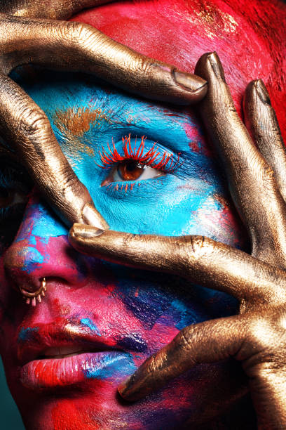 shot of an attractive young woman posing alone in the studio with paint on her face - beautiful confidence bizarre exoticism imagens e fotografias de stock