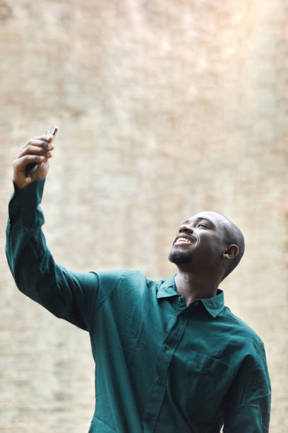 istock A young man takes a selfie with a smartphone. 1386261325