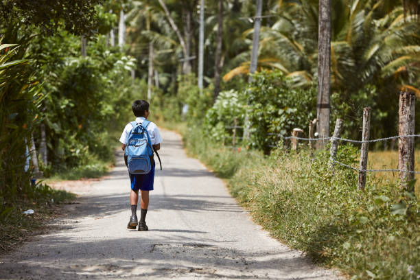Schoolboy in uniform is walking to school