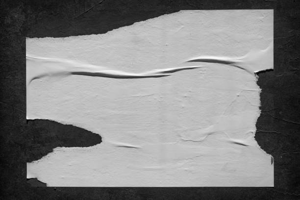 istock A piece of paper on a black wall. 1386266494