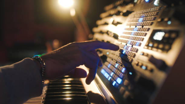 istock Hands of a man sound engineer are pressing buttons on the console 1386266663
