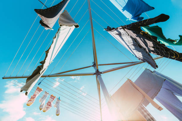 Low Angle View Of Laundry Drying On Clothesline Against Blue Sky