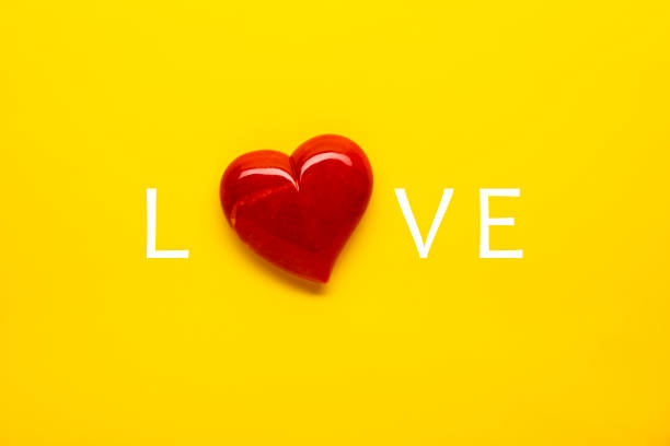 istock Red Heart Love on Bright Yellow Background 1386274331