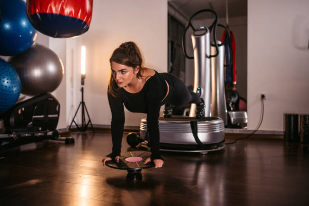 istock Young woman training on power plate 1386276552