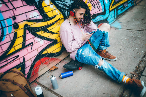 istock Graffiti artist listens to music 1386281425