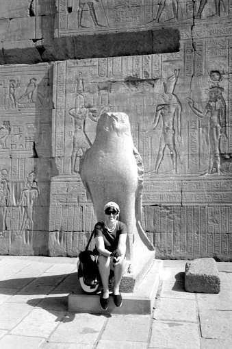 Edfu - Upper Egypt, May 1989.  The falcon god statue at the first pylon of the Ptolemaic Temple Of Horus. This Temple is dedicated to the falcon god Horus and goddess Hathor.\nPlease note that the image was scanned from an over thirty years old negative.
