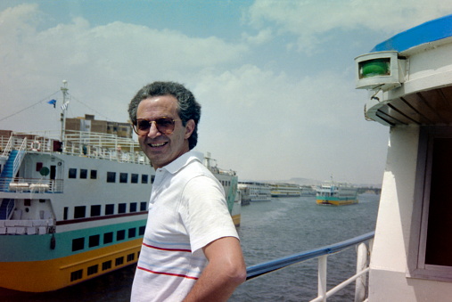 Upper Egypt - May 1989.  A Senior tourist on the sun deck of a Nile cruiser. The image were scanned from old negative.
