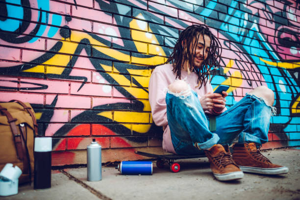istock Graffiti artist listens to music 1386283663