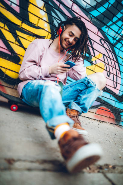 istock Graffiti artist listens to music 1386283673