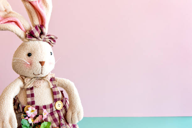 istock Plush bunny in pink and green background, easter decoration 1386283709