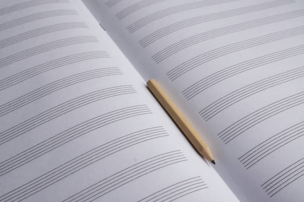 istock Music empty sheets paper and wooden pencil 1386283917
