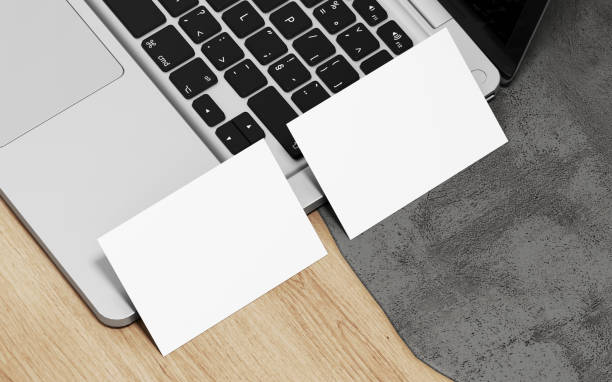 istock Professional business card design mockup on table with laptop in luxury studio scene. 1386284732