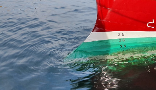 Freshly painted boat hull in water