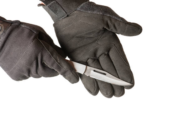 istock Man hands in gloves holding  the knife. 1386285334