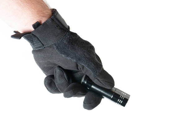 istock Male hand holding  the black gloves holding flash light. 1386285980