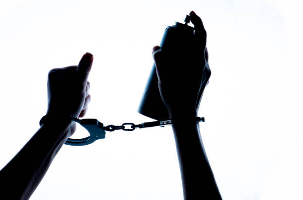 istock Female hands with handcuffs holding  spray paint. 1386286199