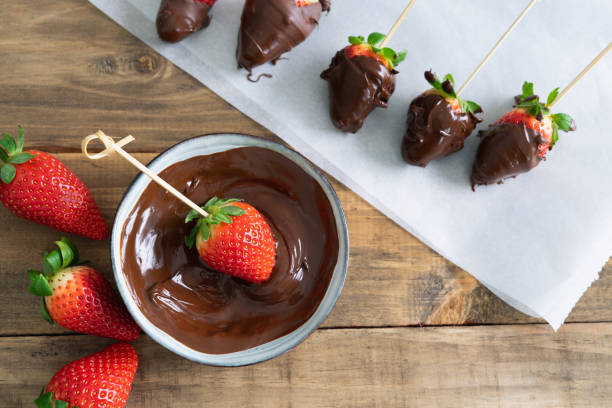 Strawberries with chocolate. Strawberries dipping process in chocolate. Copy space.