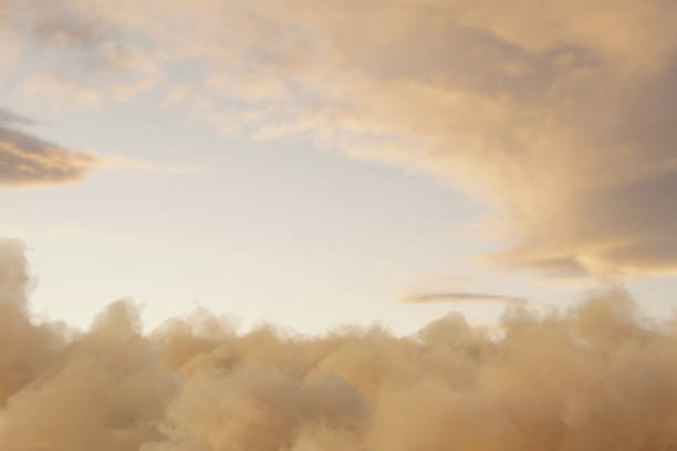view to soft yellow sky with fluffy clouds