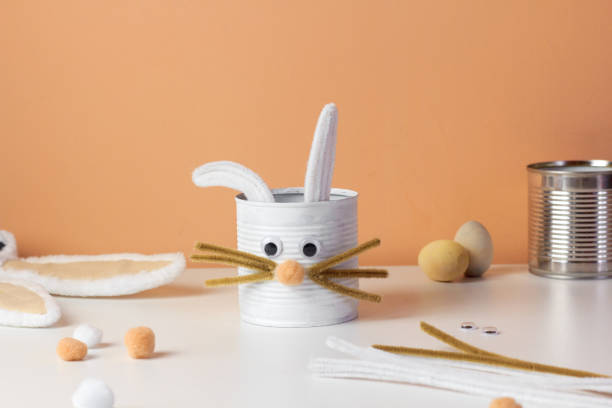 istock Reuse concept art from tin can. Eco friendly bunny craft. Handmade decoration easter rabbit. Kids DIY ideas 1386289453