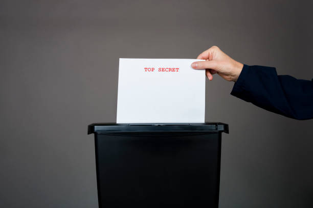 istock woman destroying top secret documents 1386289518
